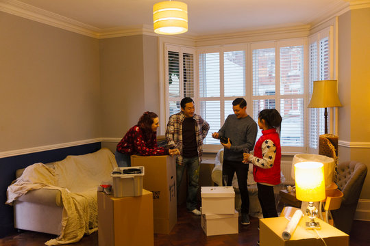 Friends taking a break from moving, celebrating with champagne