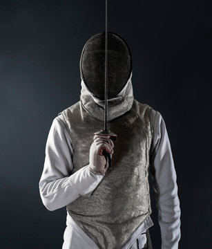 Portrait man in fencing uniform and mask