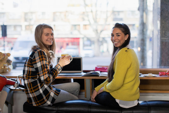 Portrait Confident Young Female College Students Studying In Cafe