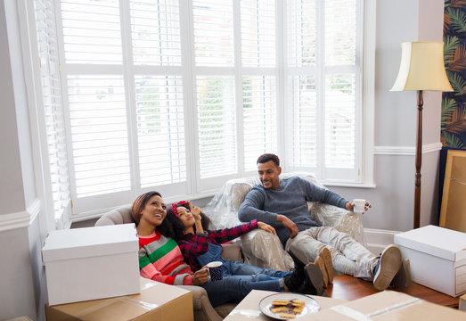 Family taking a break from packing, moving house