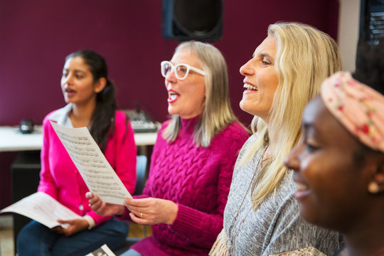 Womens choir singing in music recording studio
