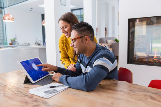 Couple paying bills at digital tablet - Powered by Adobe