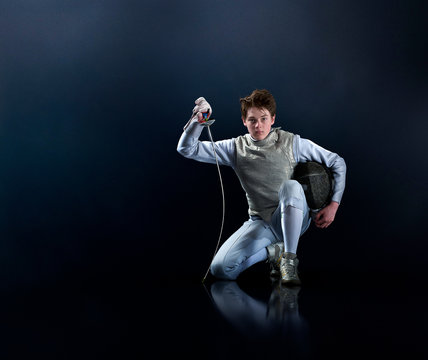 Portrait confident teenage boy fencing