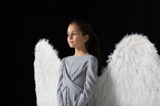Serene girl wearing angel wings