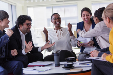 Excited business people cheering in meeting