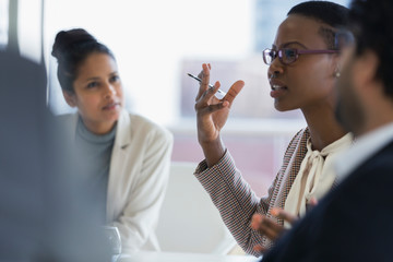 Businesswoman explaining in conference room meeting