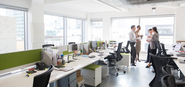 Business people talking, meeting in open plan office