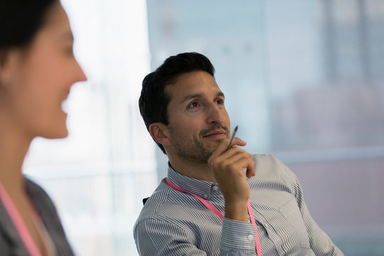 Smiling businessman listening in meeting