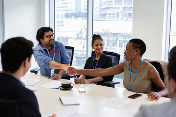 Business people shaking hands in conference room meeting