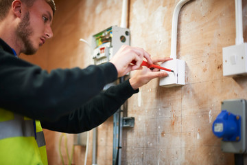 Male electrician student practicing in workshop