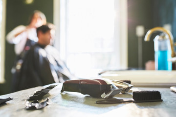 Razor, brush and tools on barbershop counter