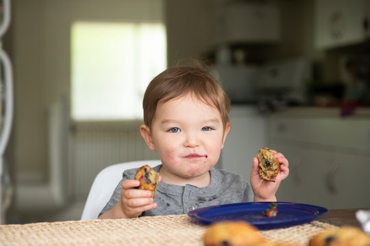 Portrait Cute Toddler Girl Eating Messy Muffin