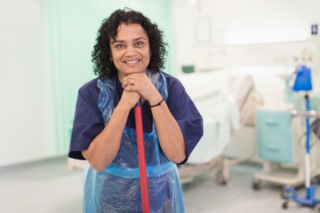 Portrait smiling, confident female orderly cleaning hospital ward
