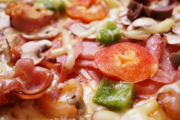 Close up of fresh baked pizza with prosciutto and bacon