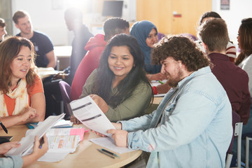 College students studying together in classroom