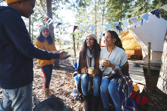 Lesbian couple with kids at campsite