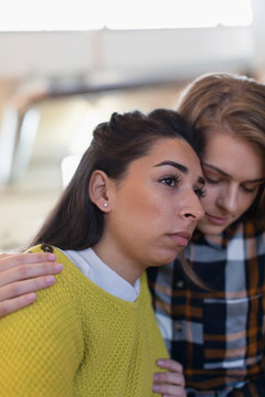 Young woman consoling crying friend