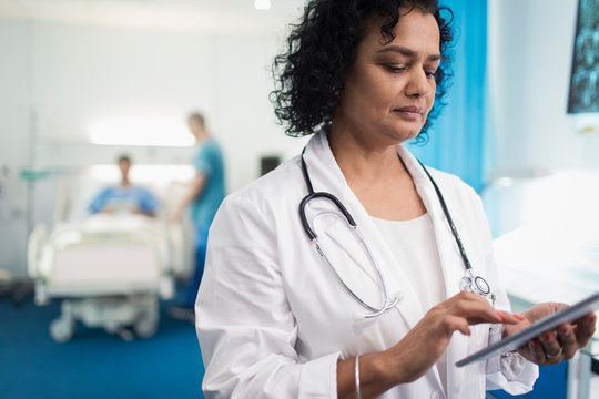 Female Doctor Using Digital Tablet In Hospital Room