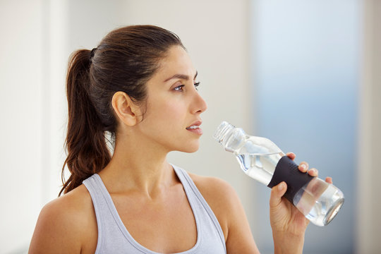 Woman drinking water post workout