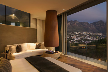 Modern luxury fireplace and home showcase bedroom with mountain and city view