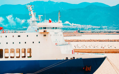Old Sardinian Port with ships at Mediterranean Sea and city of Cagliari, South Sardinia Island in...