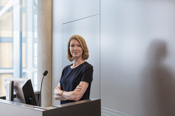 Portrait confident businesswoman at conference room podium