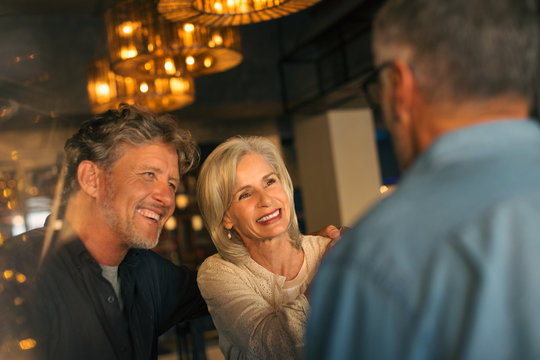Smiling friends talking in restaurant