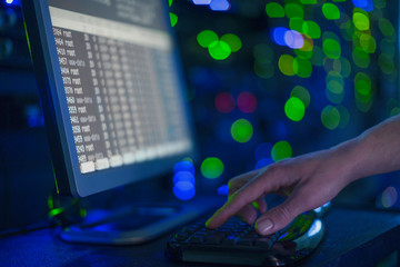 Server room technician using computer