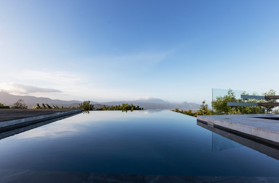 Tranquil luxury infinity pool with mountain view below blue sky