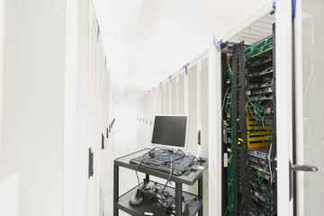 Computer on cart in server room corridor