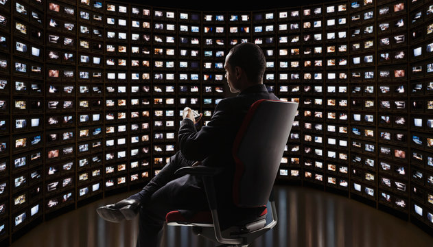 Man watching video on monitors