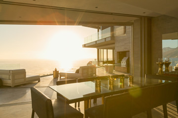 Sunset ocean view beyond modern luxury home showcase patio