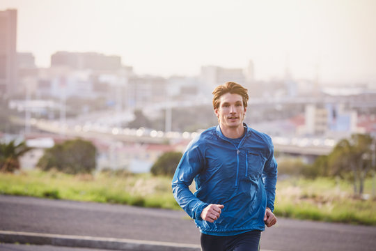 Male runner running on urban city street