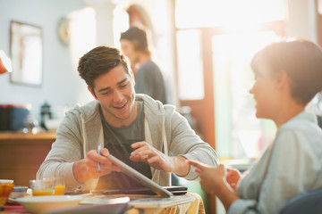 Young couple college students studying using digital tablet