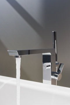 Close Up Water Falling From Modern Bathroom Faucet