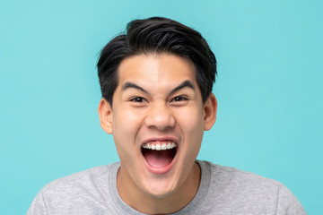 Delighted excited Asian man face