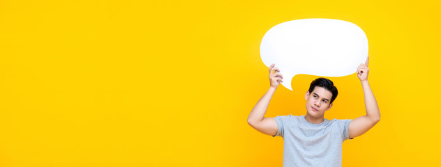 Unhappy bored young Asian man with empty speech bubble