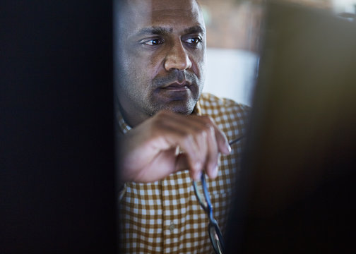 Serious focused businessman working at computer