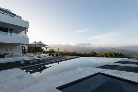Tranquil modern luxury home showcase exterior with infinity pool and mountain view
