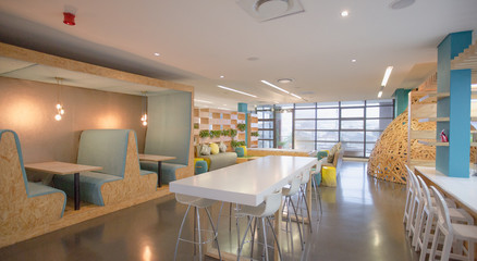 Modern, creative shared workspace with table and booths