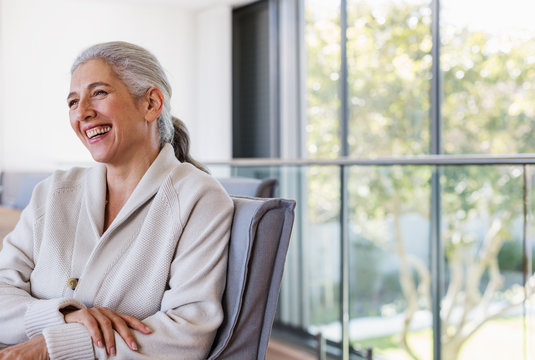 Mature woman laughing, looking away