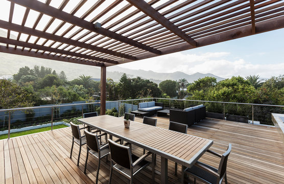 Luxury home showcase exterior wooden patio and table with mountain view