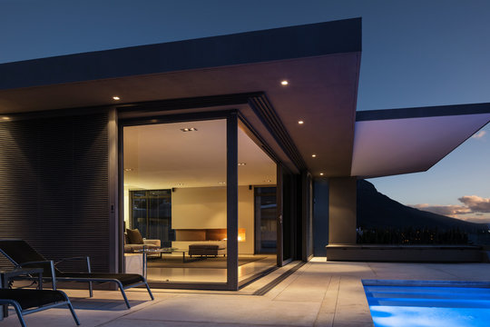 Illuminated modern home showcase exterior at night