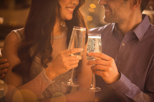 Affectionate couple toasting champagne flutes