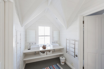 Luxury white bathroom sinks in bathroom with vaulted ceiling