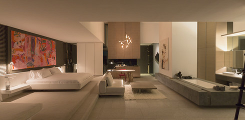 Illuminated modern, luxury home showcase bedroom