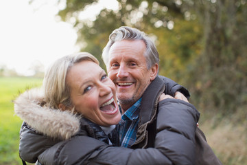 Portrait happy mature couple hugging in park