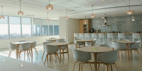 Tables and chairs in modern office cafeteria