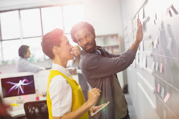 Creative business people planning, scheduling at calendar blackboard