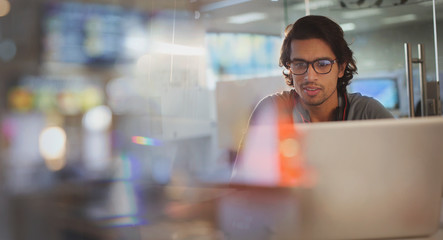 Focused businessman working at laptop in office